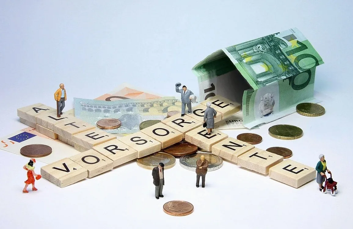 Wooden letter tiles spelling a German word for retirement provision, with euro notes, coins and small figures